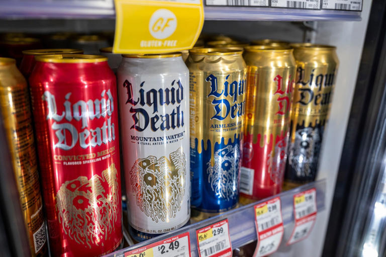 Is liquid death bad for you - Different types of liquid death cans in selling shelf.