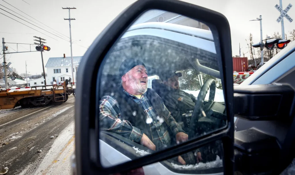 A long train grinds life to a halt every day in this rural Maine town
