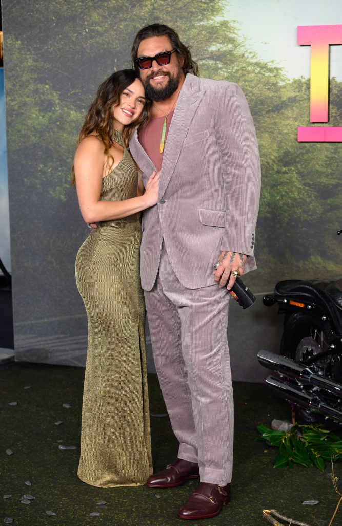 Jason Momoa and Adria Arjona's vibrant red-carpet style and playful PDA steal the show
