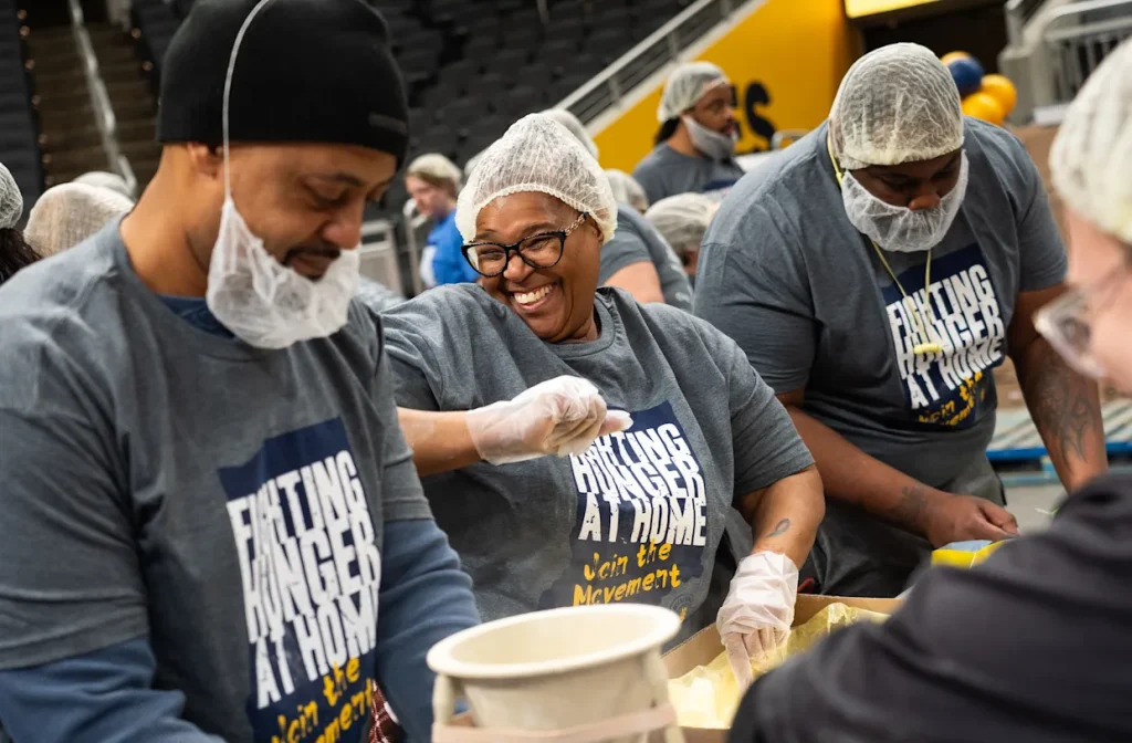 Million Meal Movement's 15th annual event: volunteers smiling, laughing, and dancing