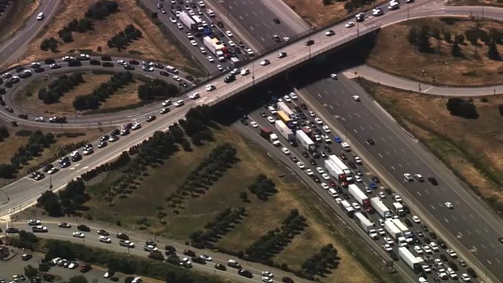 Police negotiating with individual on overpass causing traffic chaos