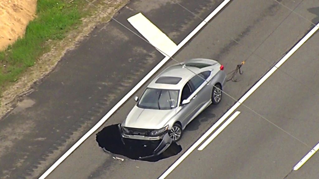 Car Swallowed by Massive Sinkhole