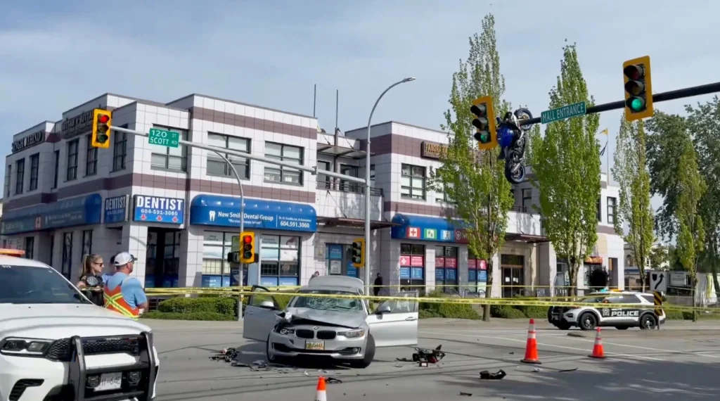 Motorcycle hangs from traffic light after wild collision