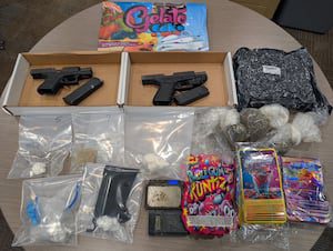 Guns, drugs seized in suspect’s car, home