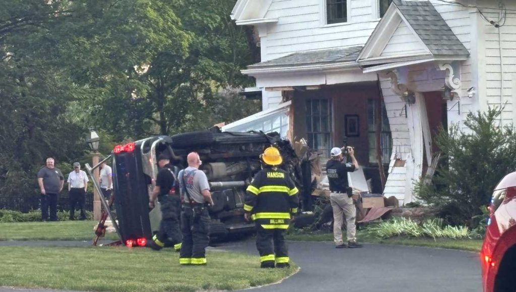Man dies after truck crashes into Mass. home